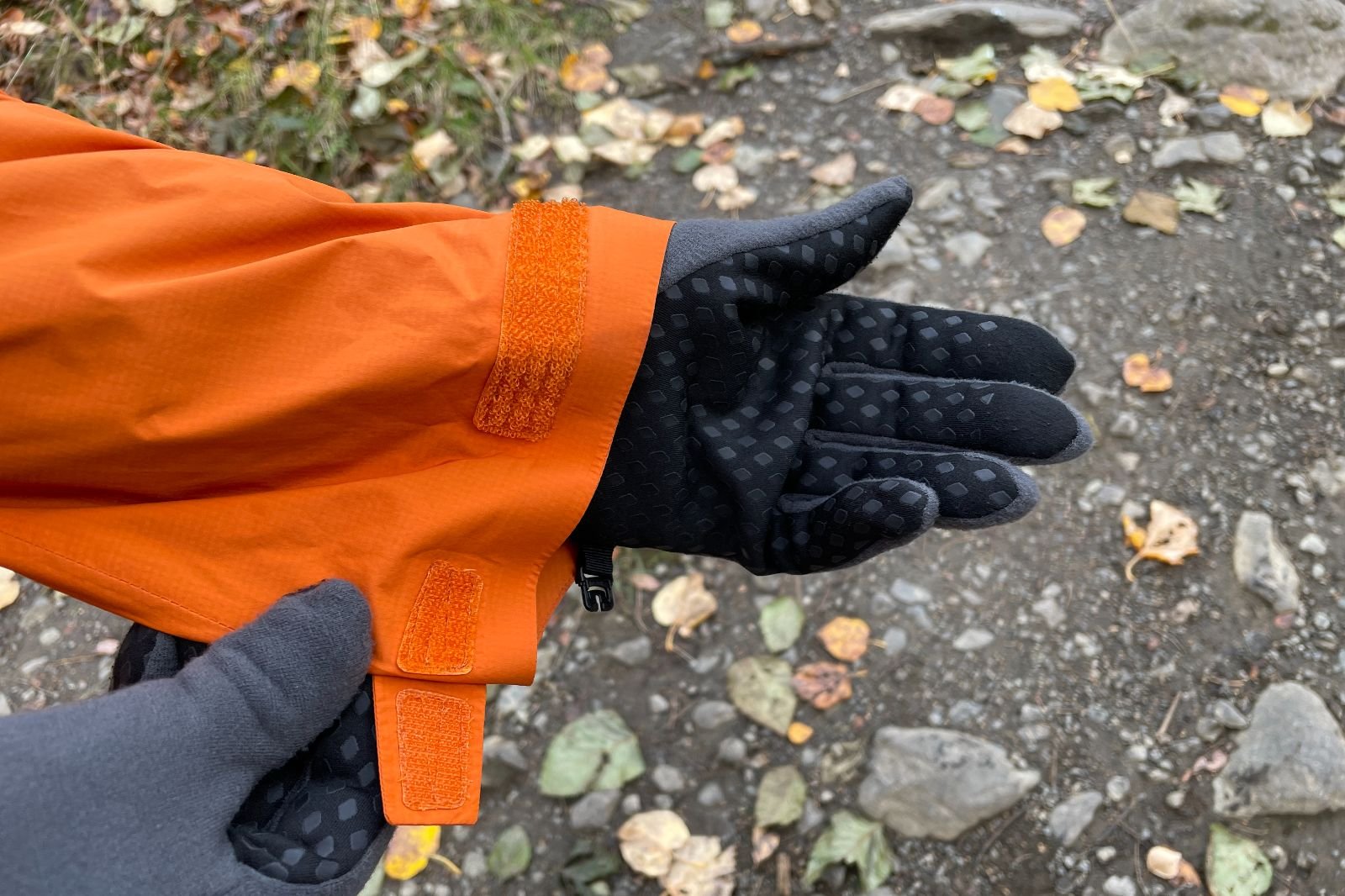 A closeup showing the short velcro tab on the cuff of a rain jacket.