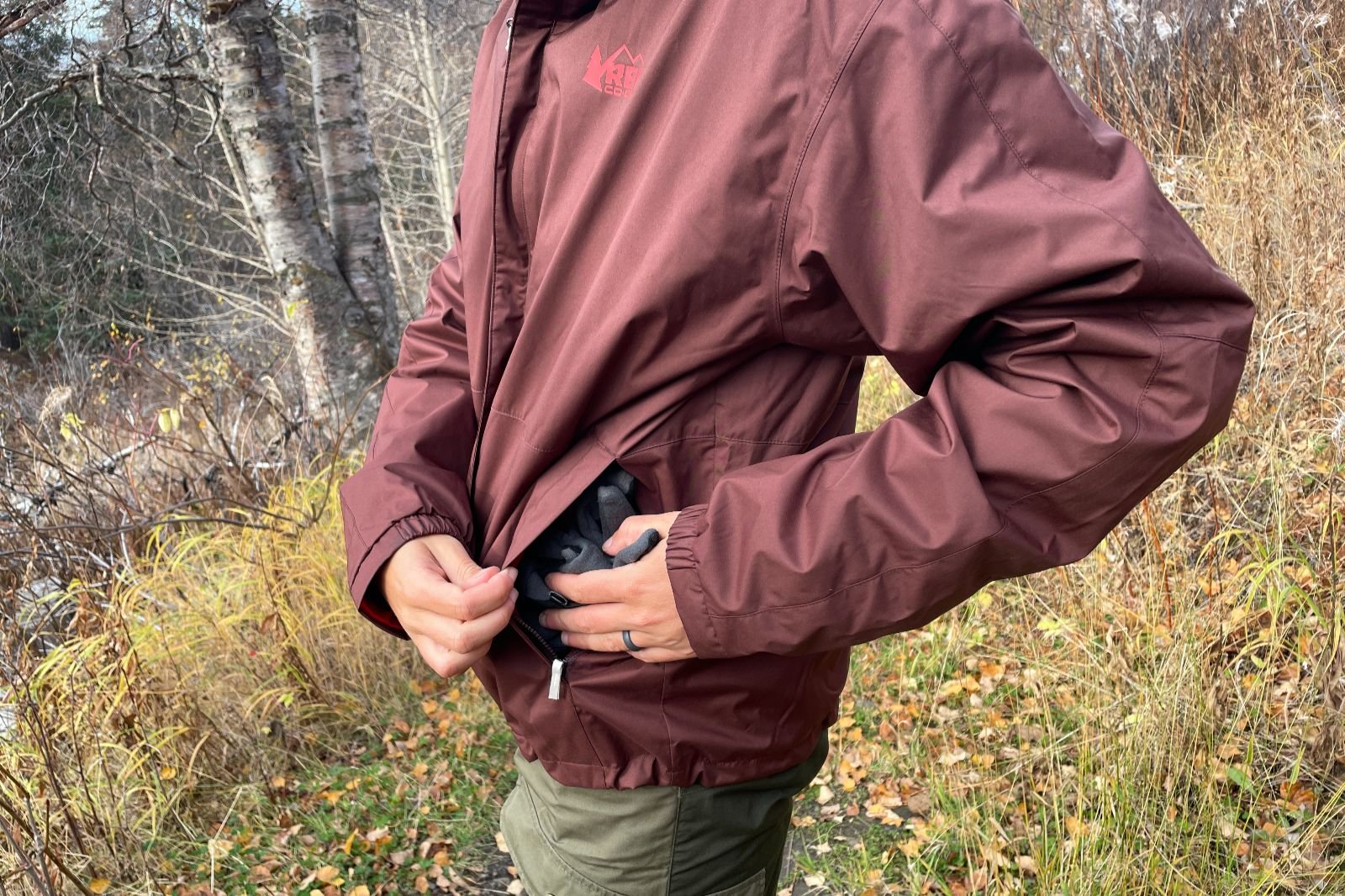 A closeup of the exterior pockets of a maroon jacket.
