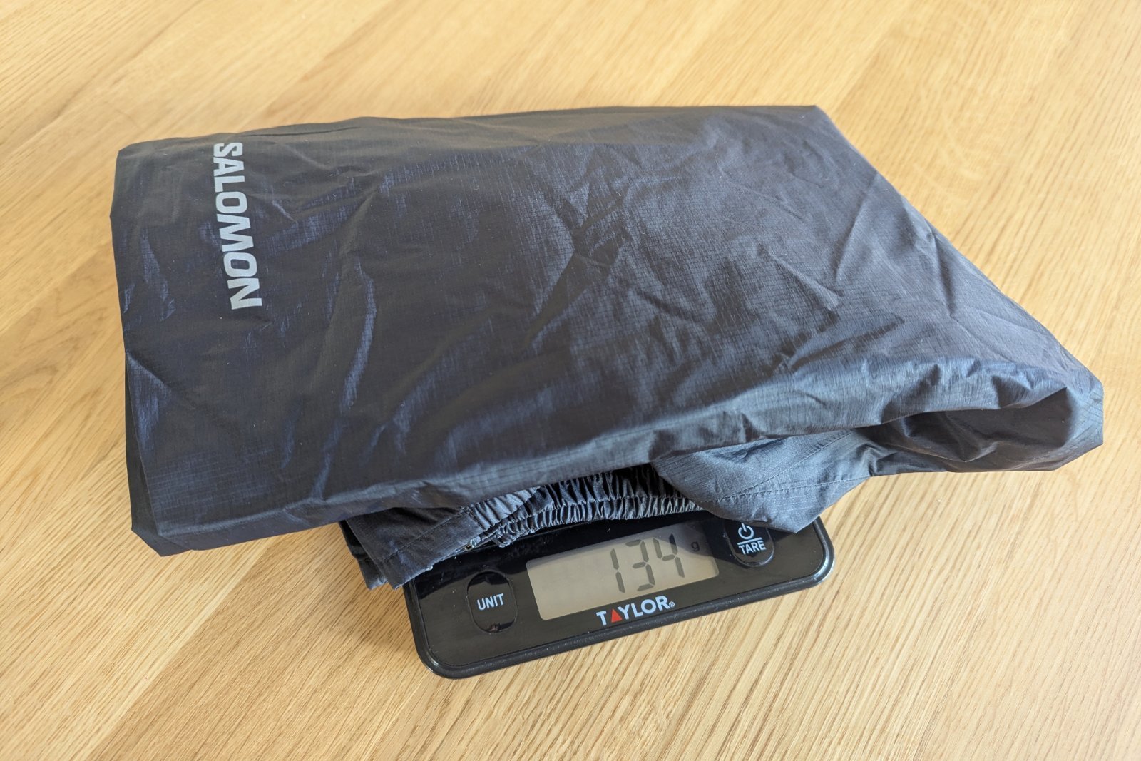 Weighing the Salomon Bonatti rain pants on a small kitchen scale.