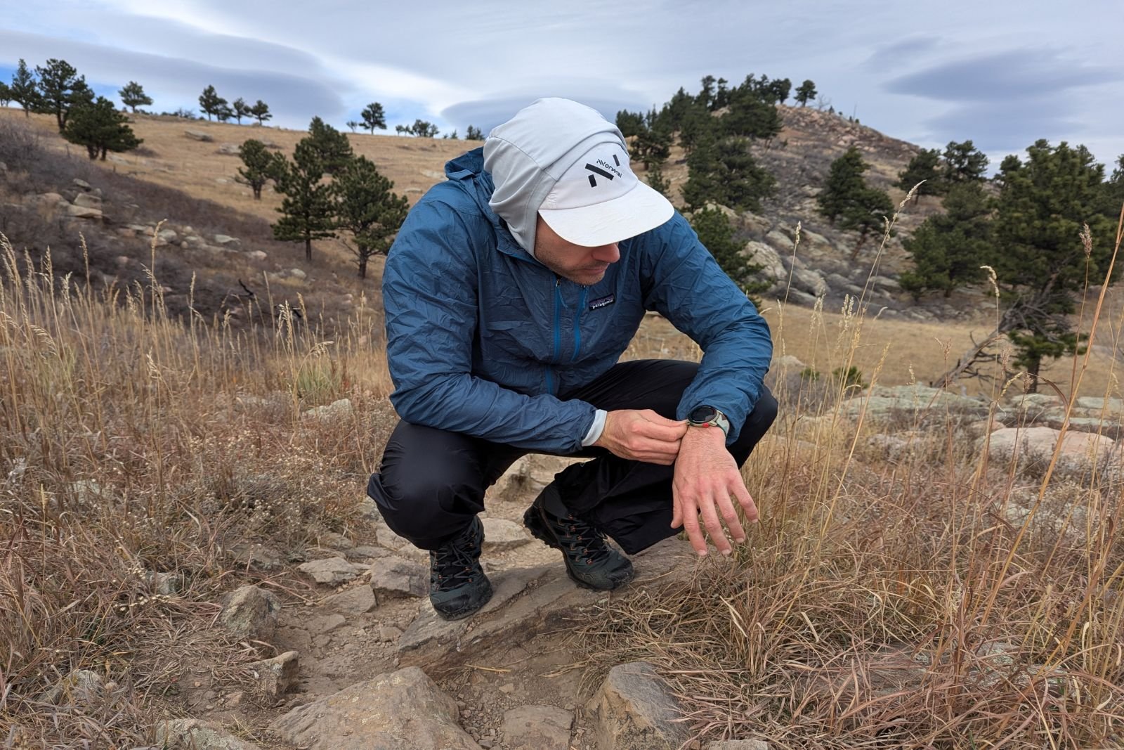 Squatting and checking the watch in the Salomon Bonatti pants.