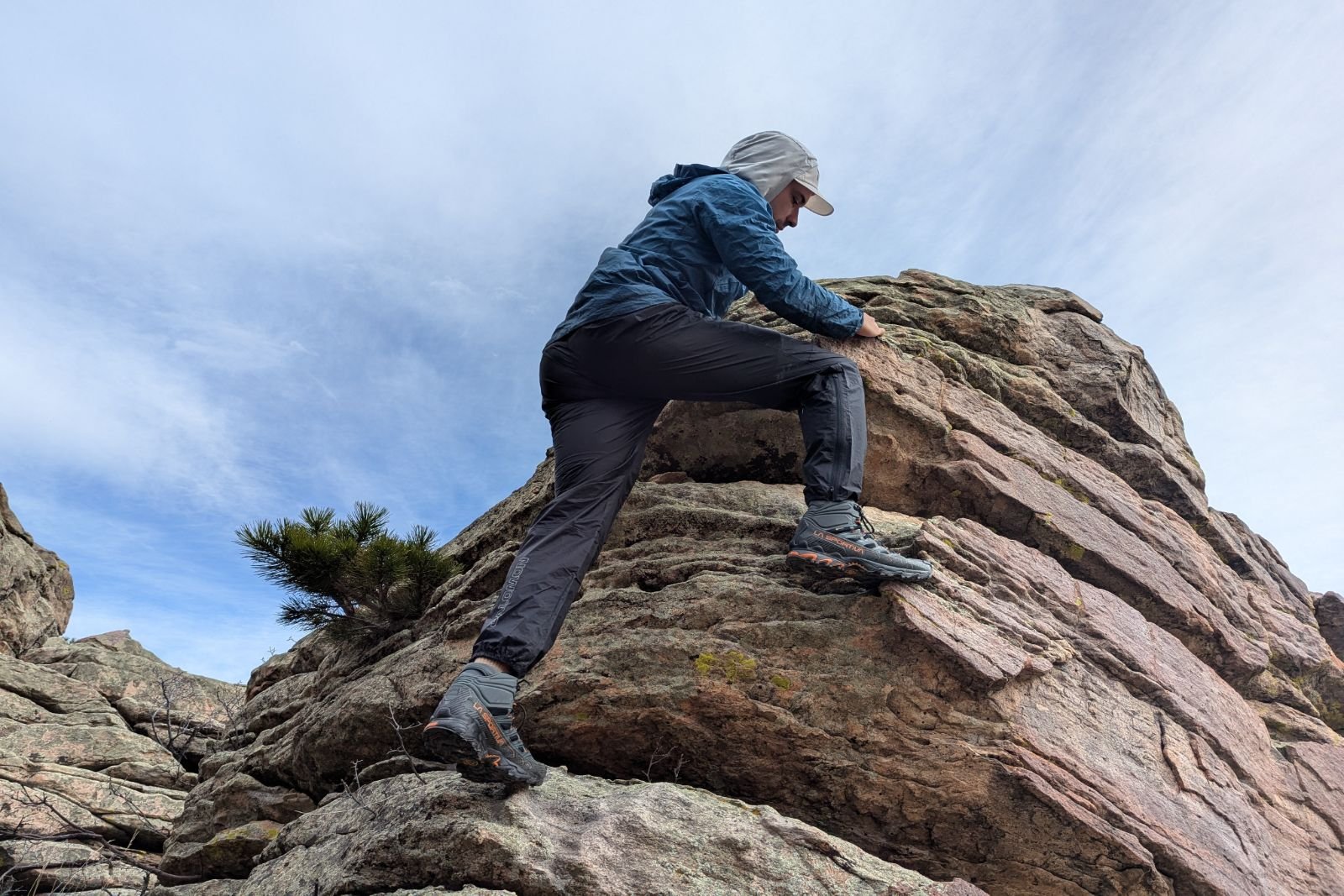 Stepping up on a boulder in the Salomon Bonatti pants.