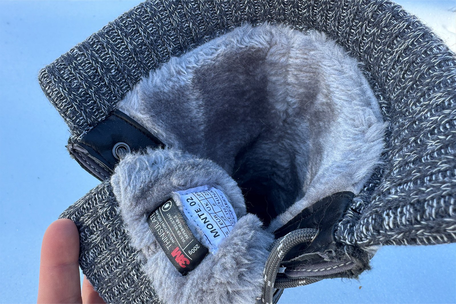 A close up of the inner lining of the Dream Pairs boots shows faux fur and a knit collar at the top.
